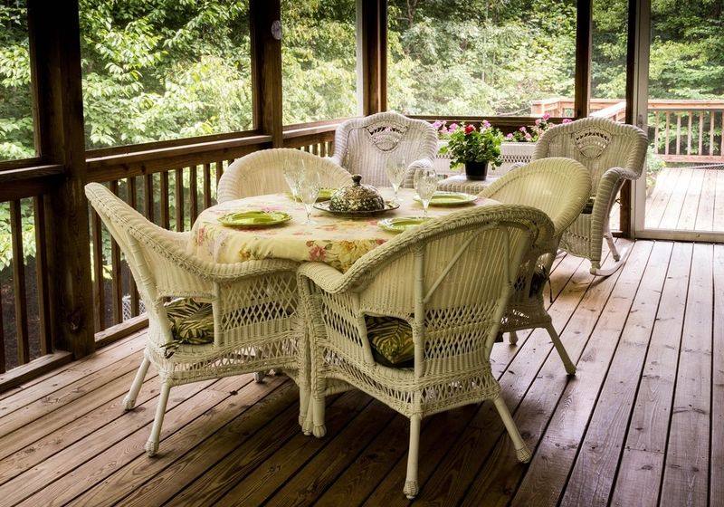 Covered wooden deck with outdoor dining furniture